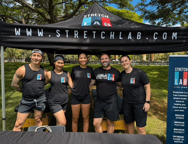 stretchlab honolulu flexologists and teams under tent in a park