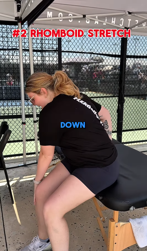 female StretchLab stretch practitioner showing a rhomboid stretch for pickleball players